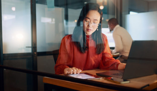 Asian tech worker working late at night