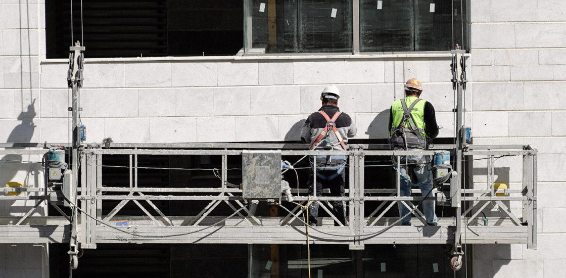 Construction workers on a lift