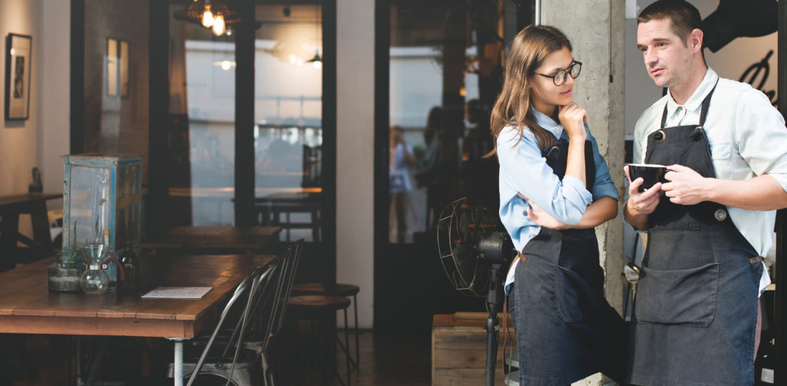 Restaurant workers discussing their employer
